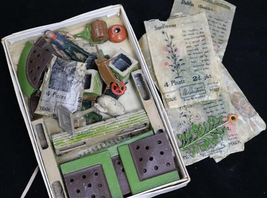 A collection of Britains miniature garden flowers, some in original packets and other items